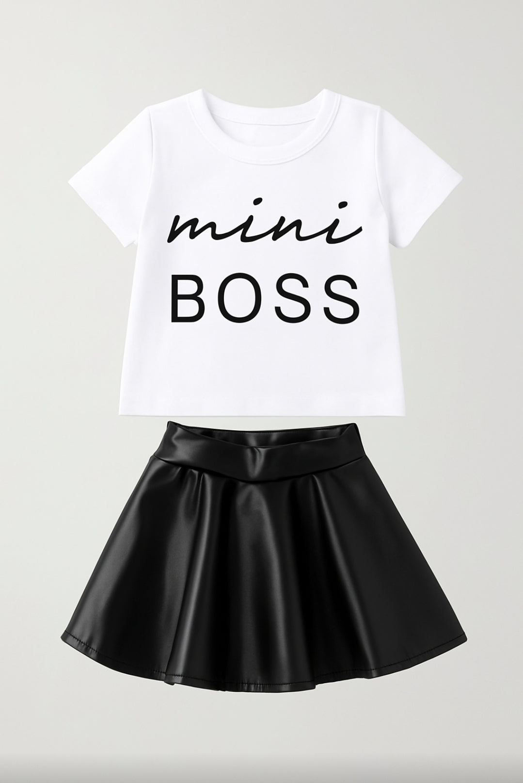 White t-shirt with 'mini BOSS' text and black leather skirt on a light gray background