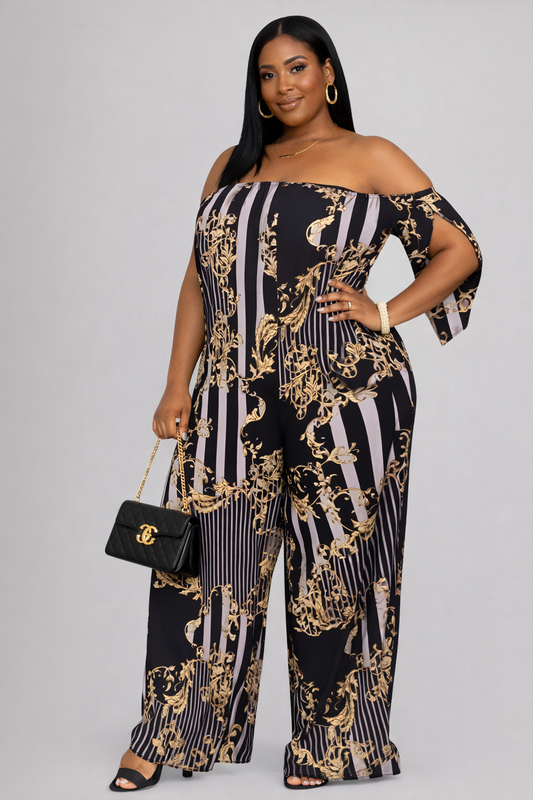 Woman wearing a black and gold patterned off-shoulder jumpsuit on a gray background