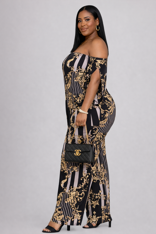 Woman wearing a black and gold patterned jumpsuit with a white background
