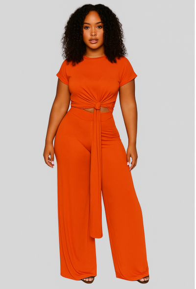 Woman wearing an orange jumpsuit on a gray background