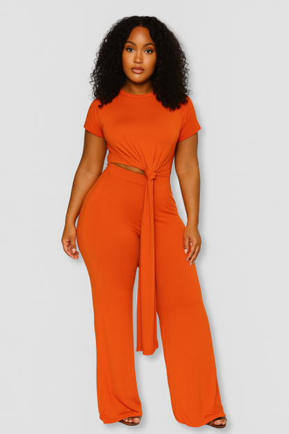 Woman wearing an orange jumpsuit on a white background