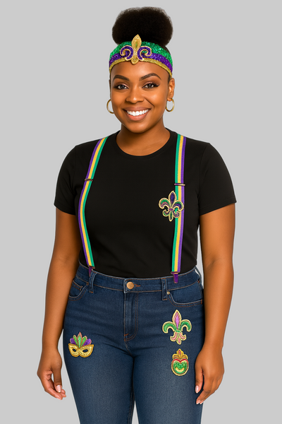 Woman wearing a black t-shirt with a colorful design, blue jeans with festive designs, and a headband with a Mardi Gras theme on a white background.