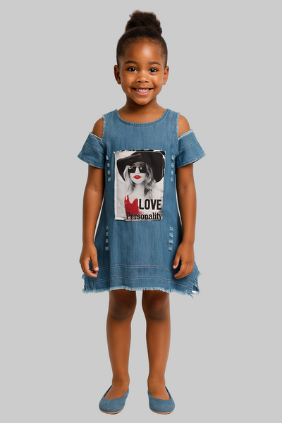 Young girl wearing a denim dress with a graphic design on a white background