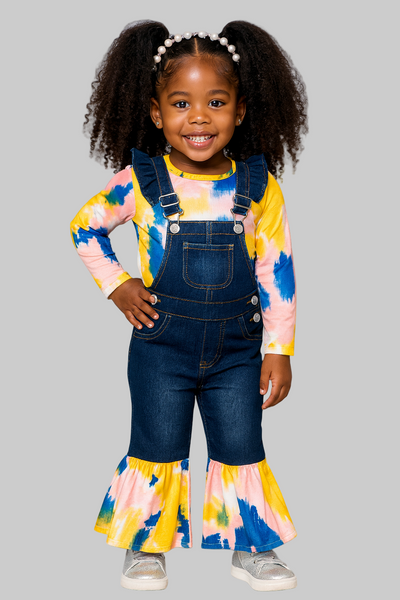 Child wearing a colorful outfit with denim overalls on a gray background