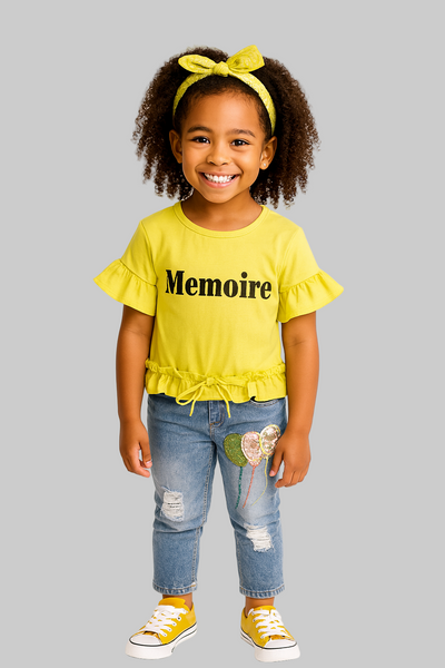 Child wearing a yellow 'Memoire' top and blue jeans with a white background