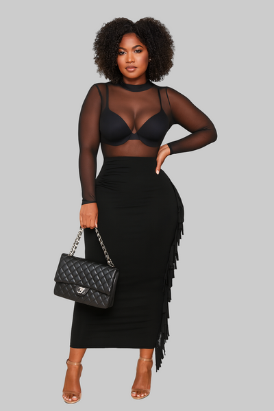 Woman wearing a black sheer top and skirt with a black handbag on a white background