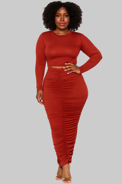 Woman wearing a red two-piece outfit on a white background