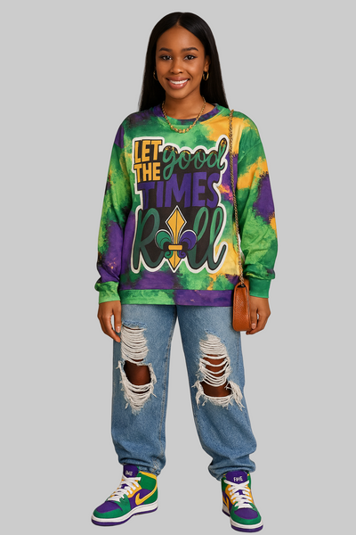 Person wearing a colorful tie-dye sweatshirt with text and ripped jeans on a plain background