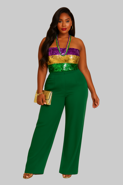 Woman wearing a green jumpsuit with a colorful top on a beige background