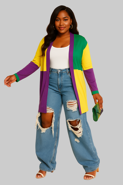 Woman wearing a colorful cardigan and ripped jeans on a beige background