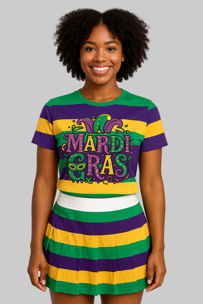 Person wearing a Mardi Gras-themed dress with purple, yellow, and green colors on a plain background.