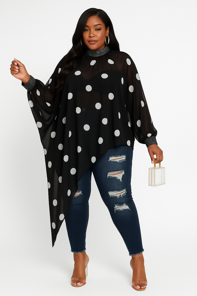 Woman wearing a black polka dot poncho and ripped jeans on a white background