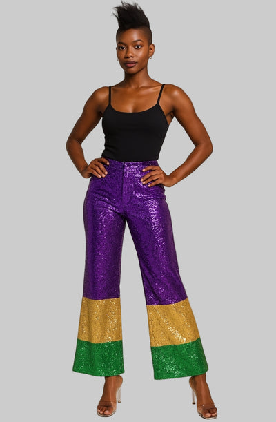 A pair of Mardi Gras showstopper pants featuring shimmering purple sequins with vibrant yellow and green bell bottoms.