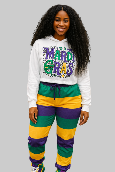 Woman wearing a Mardi Gras-themed outfit with a hoodie and pants on a paved path.