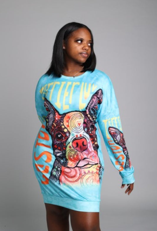 Woman wearing a colorful long-sleeve dress with a dog graphic and text on a gray background