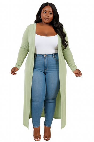 Woman wearing a long green cardigan, white top, and blue jeans on a white background