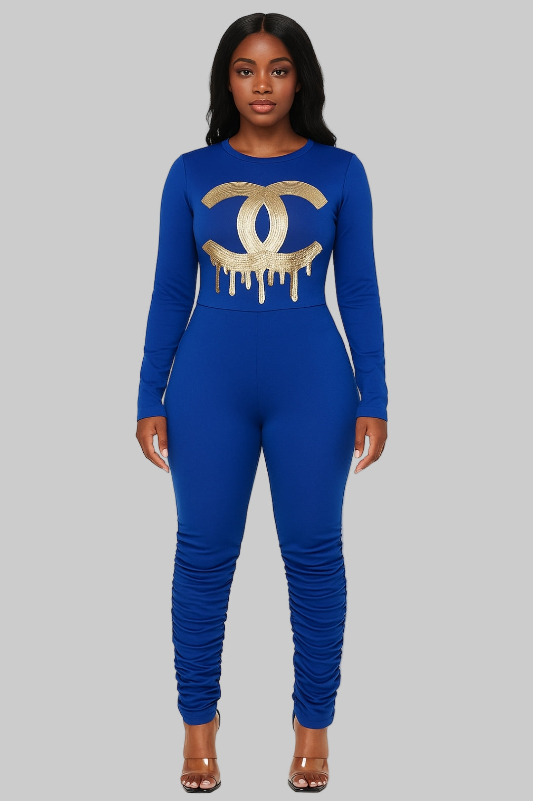 Woman wearing a blue jumpsuit with a gold logo on a white background