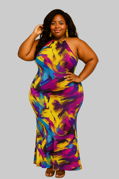Woman wearing a colorful tie-dye dress against a gray background