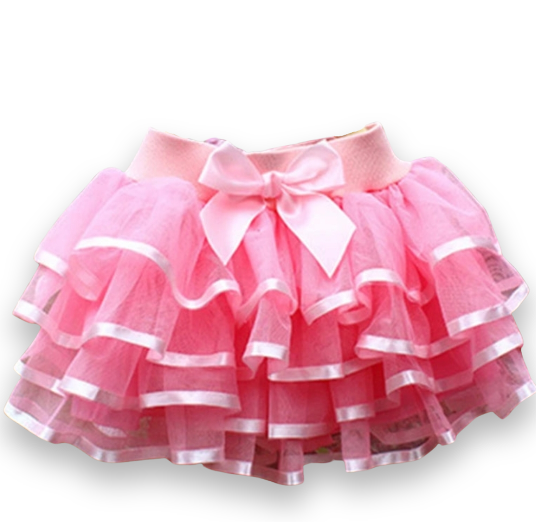 A pink tutu skirt with white ruffles and a front bow detail, designed for girls.