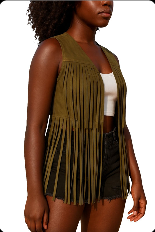 A woman wearing a sleeveless pink fringe suede vest with a white top and black shorts.