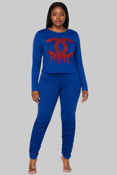 Woman wearing a blue outfit with a red logo on a white background