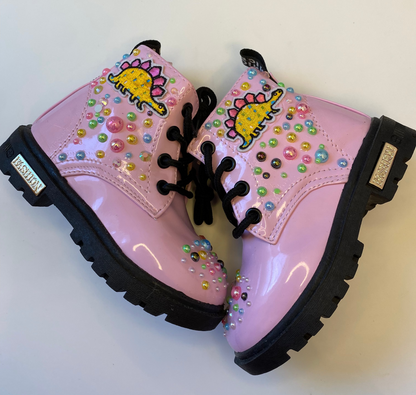 Pink boots with decorative elements on a white background