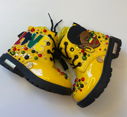 Yellow boots with decorative elements on a white background