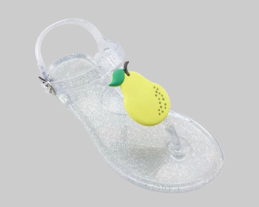 A pair of children's summer slippers with a clear body and fruit patterns, featuring a green pear-shaped detail on the strap.